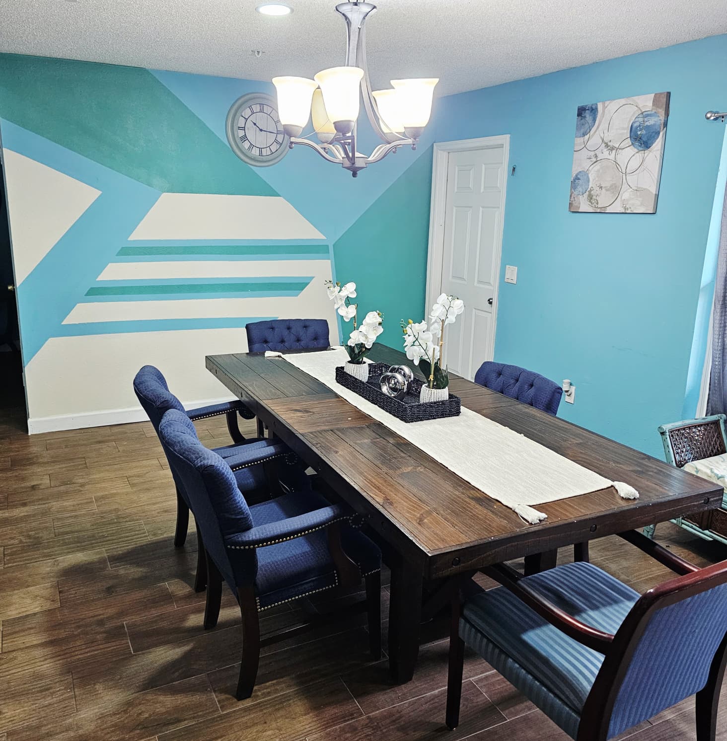Shared dining room with large table and seating for residents